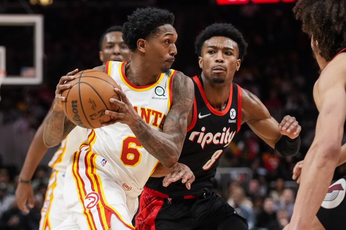 Mar 14, 2022; Atlanta, Georgia, USA; Atlanta Hawks guard Lou Williams (6) drives the ball past Portland Trail Blazers guard Brandon Williams (8) during the second half at State Farm Arena. Mandatory Credit: Dale Zanine-USA TODAY Sports