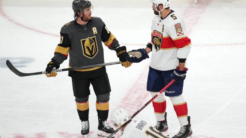 Mar 17, 2022; Las Vegas, Nevada, USA; Vegas Golden Knights center Jonathan Marchessault (81) talks to Florida Panthers defenseman Aaron Ekblad (5) during the third period at T-Mobile Arena. Mandatory Credit: Stephen R. Sylvanie-USA TODAY Sports