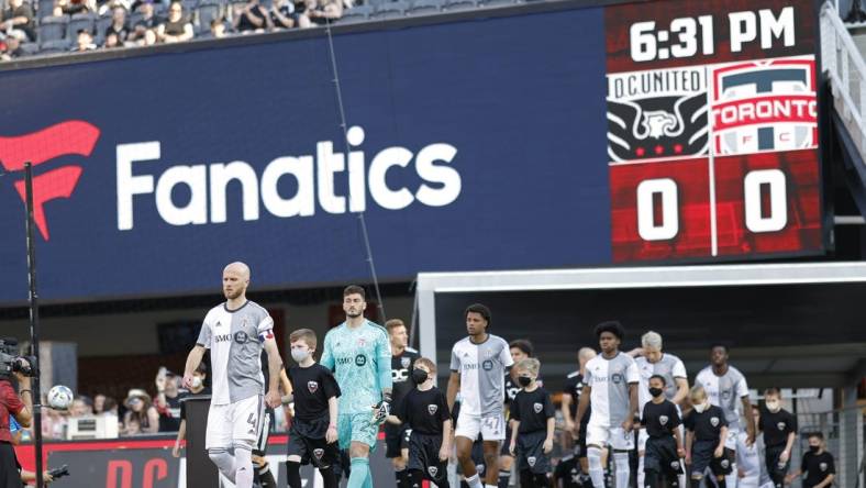 May 21, 2022; Washington, District of Columbia, USA; Toronto FC players and D.C. United players walk onto the pitch from the tunnel prior to their game at Audi Field. Mandatory Credit: Geoff Burke-USA TODAY Sports