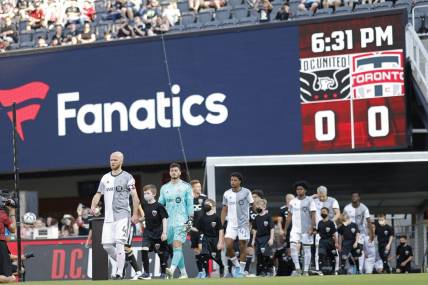 May 21, 2022; Washington, District of Columbia, USA; Toronto FC players and D.C. United players walk onto the pitch from the tunnel prior to their game at Audi Field. Mandatory Credit: Geoff Burke-USA TODAY Sports