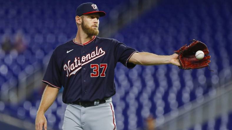 Jun 9, 2022; Miami, Florida, USA; Washington Nationals starting pitcher Stephen Strasburg (37) catches a baseball during the first inning against the Miami Marlins at loanDepot Park. Mandatory Credit: Sam Navarro-USA TODAY Sports