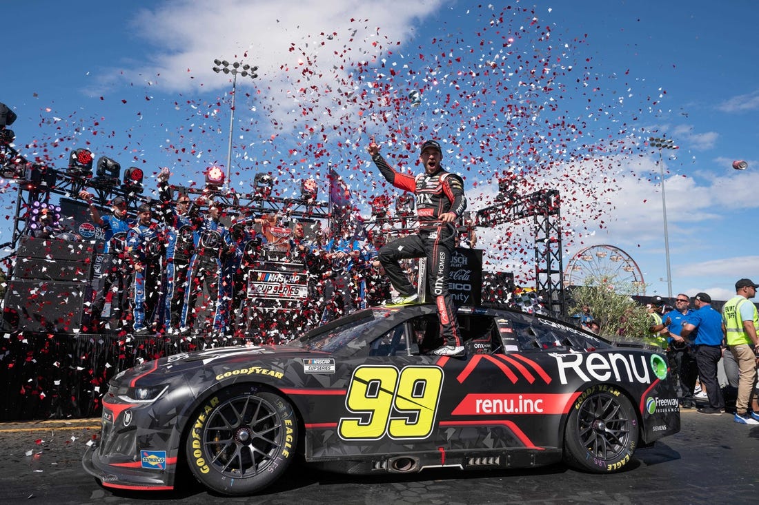 Jun 12, 2022; Sonoma, California, USA;  NASCAR Cup Series driver Daniel Suarez (99) celebrates his win of the NASCAR Toyota - Save Mart 350 race event at Sonoma Raceway. Mandatory Credit: Stan Szeto-USA TODAY Sports