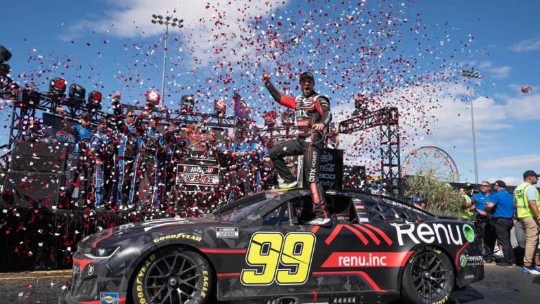 Jun 12, 2022; Sonoma, California, USA;  NASCAR Cup Series driver Daniel Suarez (99) celebrates his win of the NASCAR Toyota - Save Mart 350 race event at Sonoma Raceway. Mandatory Credit: Stan Szeto-USA TODAY Sports