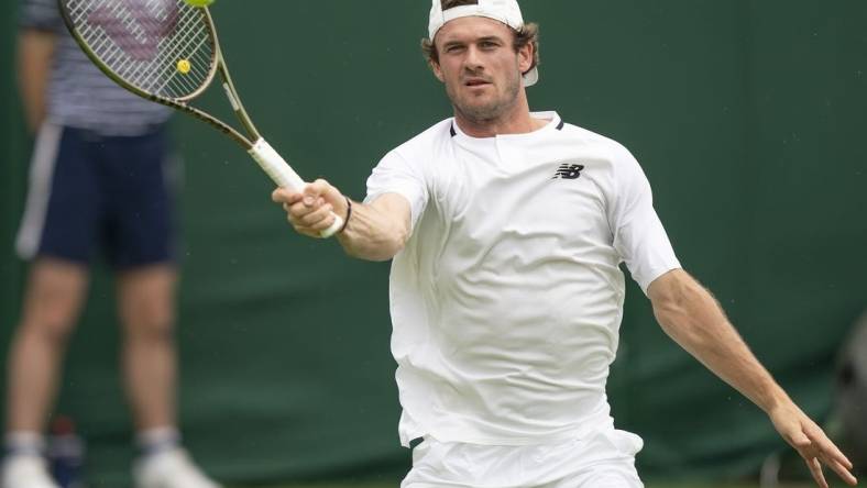 Jun 27, 2022; London, United Kingdom;  Tommy Paul (USA) returns a shot during his first round match against Fernando Verdasco (ESP) on day one at All England Lawn Tennis and Croquet Club. Mandatory Credit: Susan Mullane-USA TODAY Sports