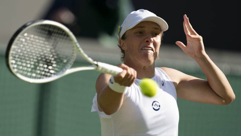 Jun 30, 2022; London, United Kingdom; Iga Swiatek (POL) returns a shot during her match against Lesley Pattinama Kerkhove (NED) on day four at All England Lawn Tennis and Croquet Club. Mandatory Credit: Susan Mullane-USA TODAY Sports