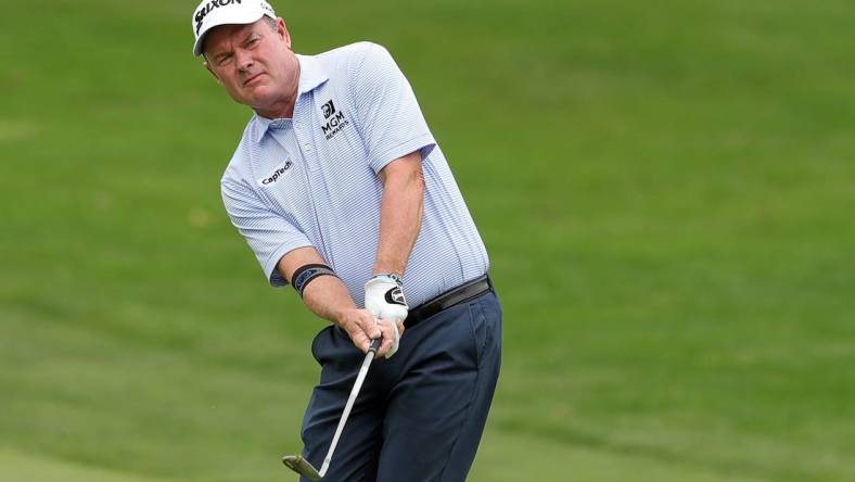 Joe Durant chips onto the green on the 4th hole during second round of the Bridgestone Senior Players Tournament at Firestone Country Club on Friday.

Bridgestonejl 10