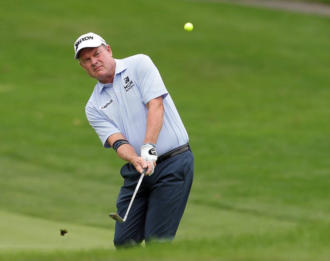 Joe Durant chips onto the green on the 4th hole during second round of the Bridgestone Senior Players Tournament at Firestone Country Club on Friday.

Bridgestonejl 10