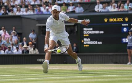 Jul 10, 2022; London, United Kingdom; Novak Djokovic (SRB) returns a shot during the men   s final against Nick Kyrgios (not pictured) on day 14 at All England Lawn Tennis and Croquet Club. Mandatory Credit: Susan Mullane-USA TODAY Sports