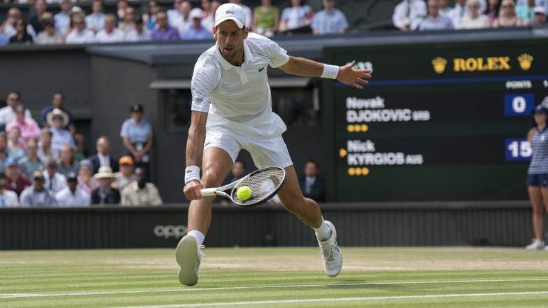 Jul 10, 2022; London, United Kingdom; Novak Djokovic (SRB) returns a shot during the men   s final against Nick Kyrgios (not pictured) on day 14 at All England Lawn Tennis and Croquet Club. Mandatory Credit: Susan Mullane-USA TODAY Sports