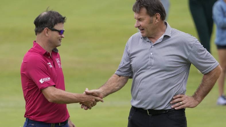 (File Photo) Zach Johnson 
(Left) and Nick Faldo shake hands on the 18th green during the Celebration of Champions at the 150th Open Championship golf tournament at St. Andrews Old Course. Mandatory Credit: Michael Madrid-USA TODAY Sports