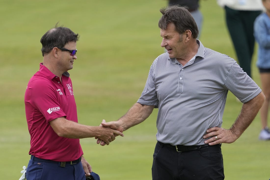 (File Photo) Zach Johnson 
(Left) and Nick Faldo shake hands on the 18th green during the Celebration of Champions at the 150th Open Championship golf tournament at St. Andrews Old Course. Mandatory Credit: Michael Madrid-USA TODAY Sports