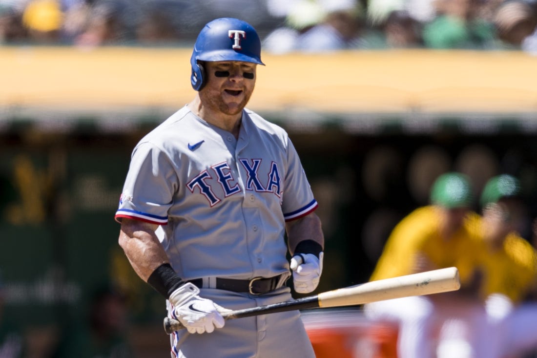 Jul 24, 2022; Oakland, California, USA;  Texas Rangers left fielder Kole Calhoun (56) reacts after a called third strike during the sixth inning of the game against the Oakland Athletics at RingCentral Coliseum. Mandatory Credit: John Hefti-USA TODAY Sports