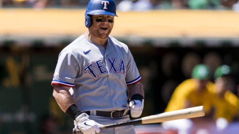 Jul 24, 2022; Oakland, California, USA;  Texas Rangers left fielder Kole Calhoun (56) reacts after a called third strike during the sixth inning of the game against the Oakland Athletics at RingCentral Coliseum. Mandatory Credit: John Hefti-USA TODAY Sports