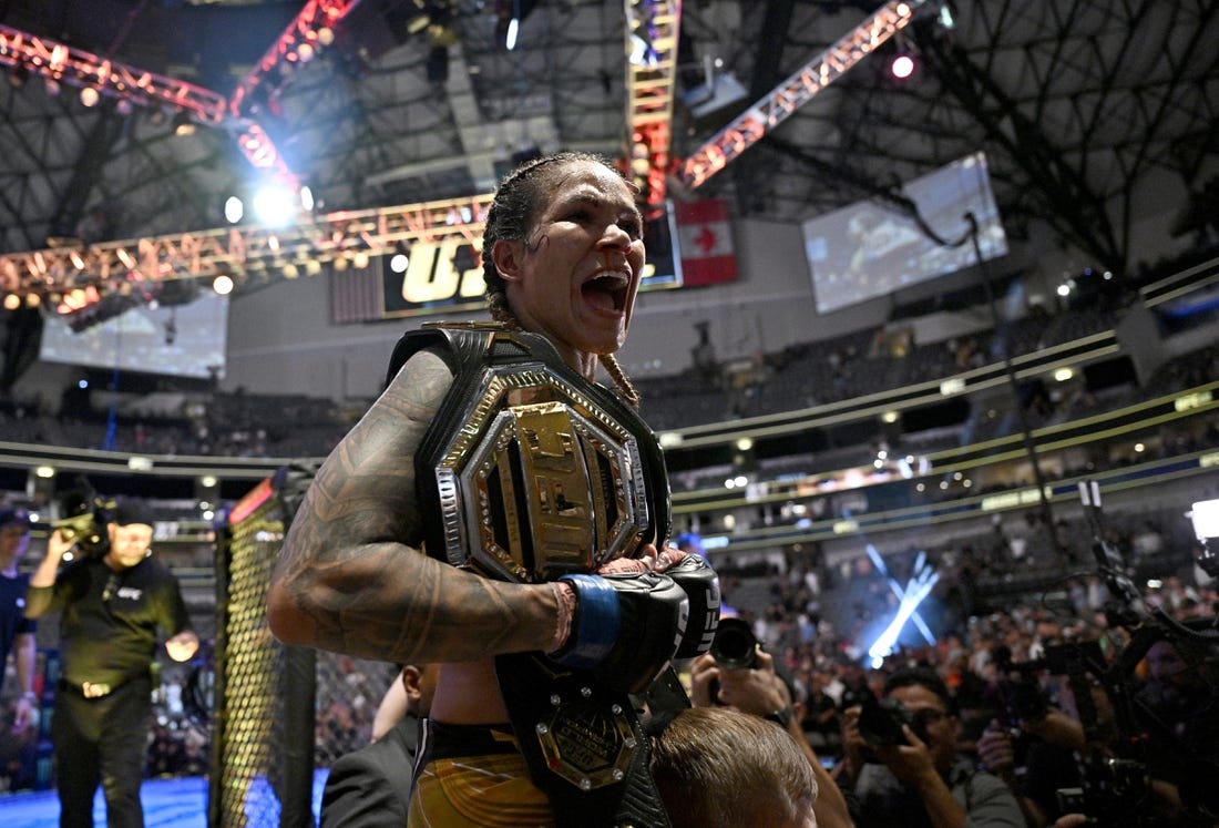 Jul 30, 2022; Dallas, TX, USA; Amanda Nunes (blue gloves) reacts after defeating Julianna Pena (not pictured) in a women   s bantamweight title bout during UFC 277 at the American Airlines Center. Mandatory Credit: Jerome Miron-USA TODAY Sports