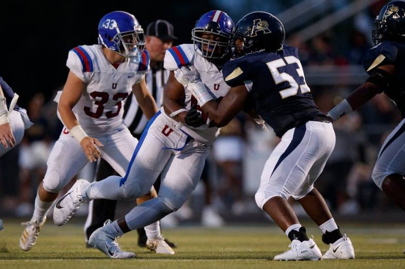 Dion Stutts (62) of MUS and Tre Jones (53) of Arlington  during the game between the Arlington Tigers and MUS Owls on Friday August, 19th 2022 in Arlington, Tn (Justin Ford/Special to the Commercial Appeal)

Arlingtonvsmus0020