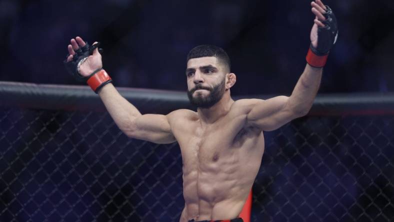 Aug 20, 2022; Salt Lake City, Utah, USA; Amir Albazi (red gloves) reacts after defeating Francisco Figueiredo (blue gloves) during UFC 278 at Vivint Arena. Mandatory Credit: Jeffrey Swinger-USA TODAY Sports