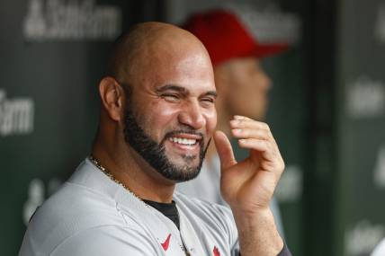 Aug 25, 2022; Chicago, Illinois, USA; St. Louis Cardinals designated hitter Albert Pujols (5) smiles in the dugout during the ninth inning against the Chicago Cubs at Wrigley Field. Mandatory Credit: Kamil Krzaczynski-USA TODAY Sports