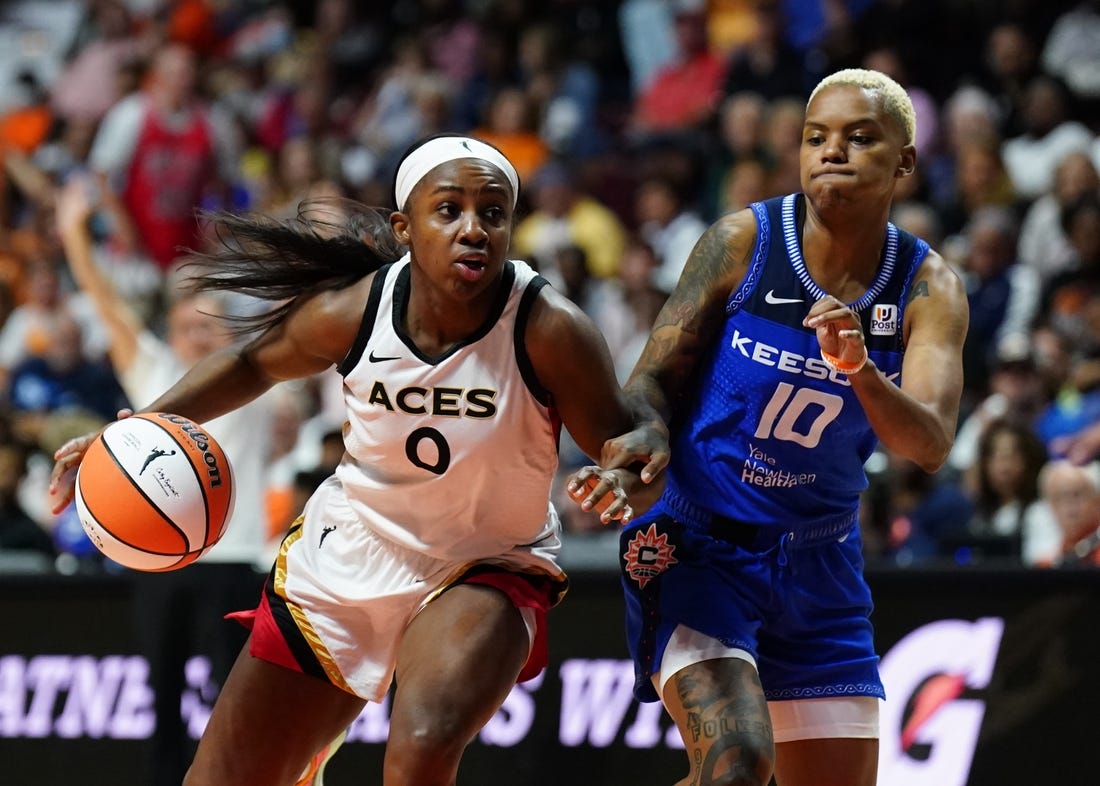 Sep 15, 2022; Uncasville, Connecticut, USA; Las Vegas Aces guard Jackie Young (0) drives the ball against Connecticut Sun guard Courtney Williams (10) in the second half during game three of the 2022 WNBA Finals at Mohegan Sun Arena. Mandatory Credit: David Butler II-USA TODAY Sports