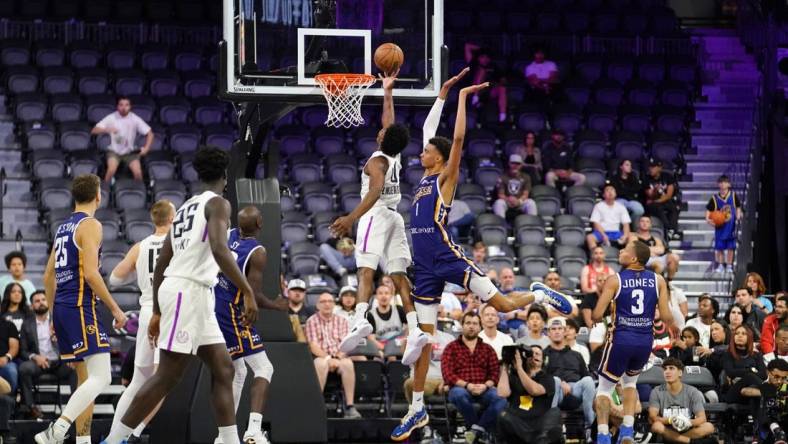 Oct 4, 2022; Henderson, NV, USA; NBA G League Ignite guard Scoot Henderson (0) scores a layup against Boulogne-Levallois Metropolitans 92 forward Victor Wembanyama (1) during the fourth quarter at The Dollar Loan Center. Mandatory Credit: Lucas Peltier-USA TODAY Sports