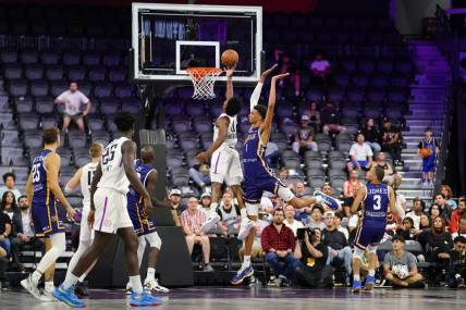 Oct 4, 2022; Henderson, NV, USA; NBA G League Ignite guard Scoot Henderson (0) scores a layup against Boulogne-Levallois Metropolitans 92 forward Victor Wembanyama (1) during the fourth quarter at The Dollar Loan Center. Mandatory Credit: Lucas Peltier-USA TODAY Sports