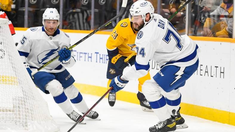 Sep 30, 2022; Nashville, Tennessee, USA;  Tampa Bay Lightning defenseman Sean Day (74) clears the puck against the Nashville Predators during the first period at Bridgestone Arena. Mandatory Credit: Steve Roberts-USA TODAY Sports