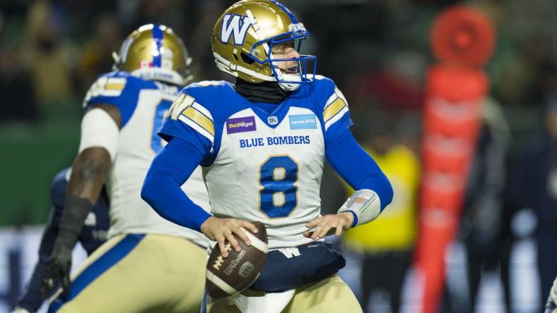 Nov 20, 2022; Regina, Saskatchewan, CAN;  Winnipeg Blue Bombers quarterback Zach Collaros (8) drops back to pass against the Toronto Argonauts in the second half. The Argonauts defeated the Blue Bombers to win the 2022 Grey Cup Championship at Mosaic Stadium. Toronto won 24-23. Mandatory Credit: Bob Frid-USA TODAY Sports