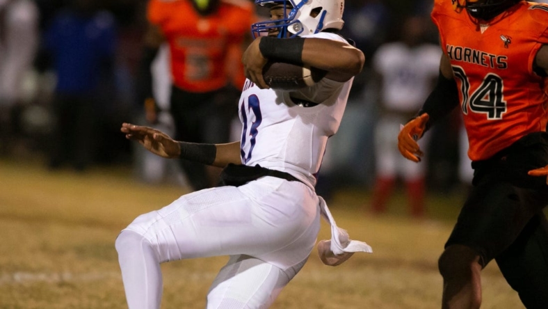 Pahokee quarterback Austin Simmons (13) slides into a first down during first half action on  Friday, Nov. 25, 2022, at Hawthorne High School in Hawthorne, Fla. during the 2022 FHSAA Football State Championships play off.  Hawthorne held on to win 21-20.  [Alan Youngblood/Gainesville Sun]

Flgai 112722 Pahokee Hawthorne 03583060