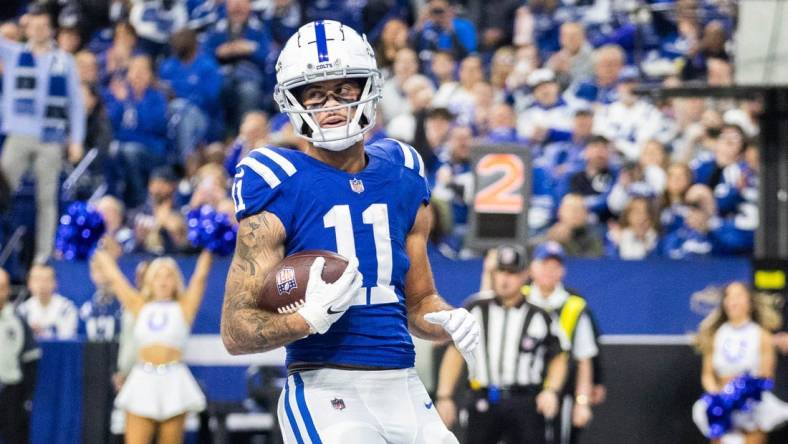 Jan 8, 2023; Indianapolis, Indiana, USA; Indianapolis Colts wide receiver Michael Pittman Jr. (11) scores a touchdown in the first quarter against the Houston Texans at Lucas Oil Stadium. Mandatory Credit: Trevor Ruszkowski-USA TODAY Sports