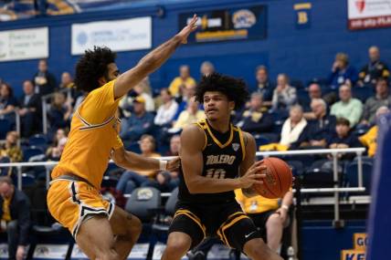 Toledo guard RayJ Dennis looks for an open teammate under the basket while being guarded by Kent State guard Sincere Carry during an NCAA basketball game, Tuesday, Jan. 10, 2023 at the Kent State M.A.C. Center.

University Of Toledo Rockets At Kent State Golden Flashes Ncaa Men S Basketball