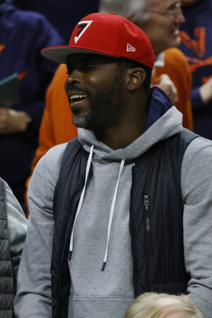 Jan 18, 2023; Charlottesville, Virginia, USA; Former NFL quarterback and Virginia Tech Hokies player Michael Vick watches from courtside during the Hokies' game against the Virginia Cavaliers in the second half at John Paul Jones Arena. Mandatory Credit: Geoff Burke-USA TODAY Sports
