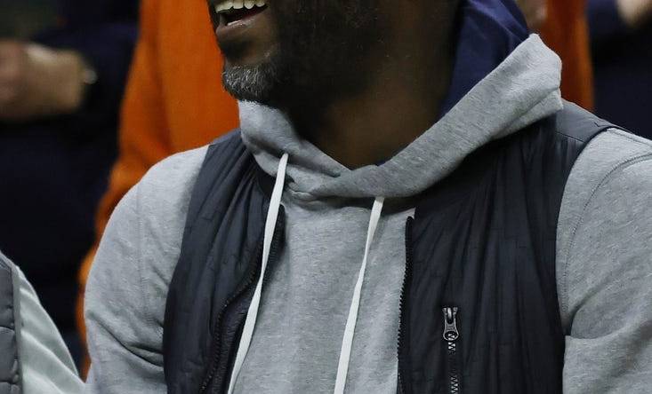 Jan 18, 2023; Charlottesville, Virginia, USA; Former NFL quarterback and Virginia Tech Hokies player Michael Vick watches from courtside during the Hokies' game against the Virginia Cavaliers in the second half at John Paul Jones Arena. Mandatory Credit: Geoff Burke-USA TODAY Sports