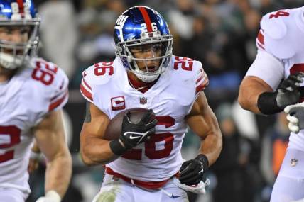 Jan 21, 2023; Philadelphia, Pennsylvania, USA; New York Giants running back Saquon Barkley (26) looks for room to run against the Philadelphia Eagles during an NFC divisional round game at Lincoln Financial Field. Mandatory Credit: Eric Hartline-USA TODAY Sports