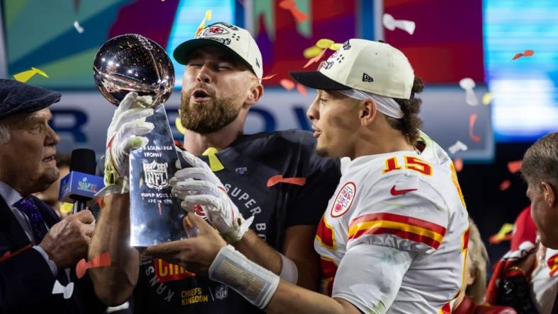 Feb 12, 2023; Glendale, Arizona, US; Kansas City Chiefs quarterback Patrick Mahomes (right) and tight end Travis Kelce celebrate with the Vince Lombardi Trophy after defeating the Philadelphia Eagles during Super Bowl LVII at State Farm Stadium. Mandatory Credit: Mark J. Rebilas-USA TODAY Sports