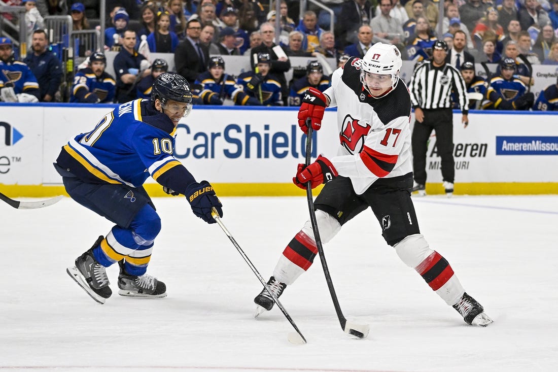 Feb 16, 2023; St. Louis, Missouri, USA;  New Jersey Devils center Yegor Sharangovich (17) shoots as St. Louis Blues center Brayden Schenn (10) defends during the first period at Enterprise Center. Mandatory Credit: Jeff Curry-USA TODAY Sports