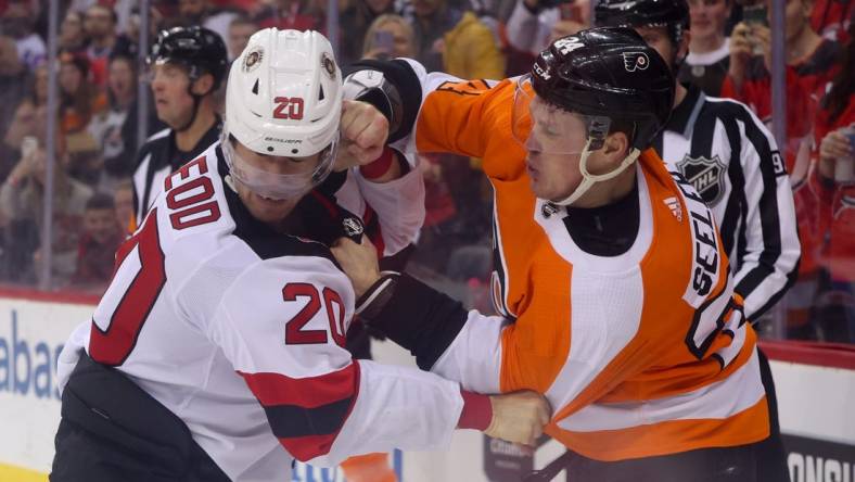 Feb 25, 2023; Newark, New Jersey, USA; New Jersey Devils center Michael McLeod (20) and Philadelphia Flyers defenseman Nick Seeler (24) fight during the second period at Prudential Center. Mandatory Credit: Ed Mulholland-USA TODAY Sports