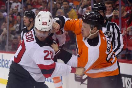 Feb 25, 2023; Newark, New Jersey, USA; New Jersey Devils center Michael McLeod (20) and Philadelphia Flyers defenseman Nick Seeler (24) fight during the second period at Prudential Center. Mandatory Credit: Ed Mulholland-USA TODAY Sports