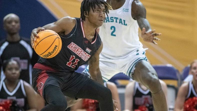 Terrance Ford Jr. (11) controls the ball during the Coastal Carolina vs. Arkansas State men   s basketball game in the first round of the Sun Belt Basketball Championship tournament at the Bay Center in Pensacola on Tuesday, Feb. 28, 2023.

Coastal Carolina Vs Arkansas State Men S Basketball