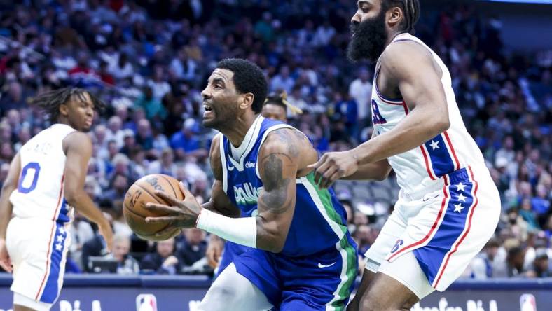 Mar 2, 2023; Dallas, Texas, USA;  Dallas Mavericks guard Kyrie Irving (2) drives to the basket past Philadelphia 76ers guard James Harden (1) during the first quarter at American Airlines Center. Mandatory Credit: Kevin Jairaj-USA TODAY Sports