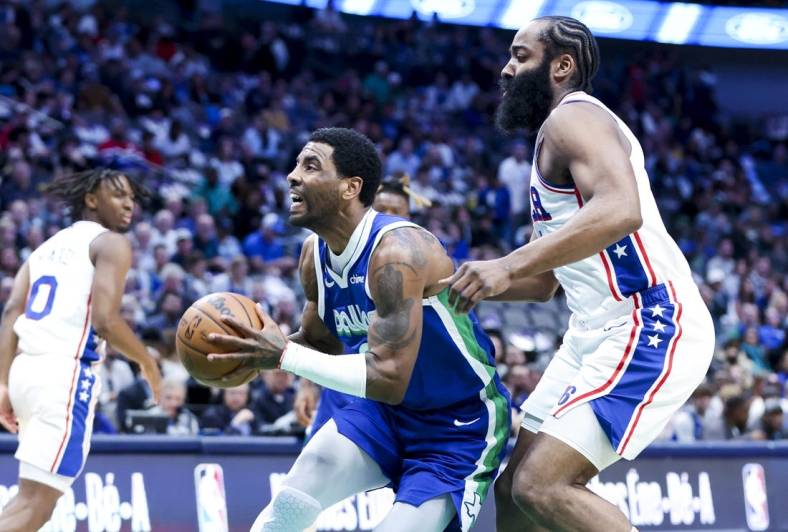 Mar 2, 2023; Dallas, Texas, USA;  Dallas Mavericks guard Kyrie Irving (2) drives to the basket past Philadelphia 76ers guard James Harden (1) during the first quarter at American Airlines Center. Mandatory Credit: Kevin Jairaj-USA TODAY Sports