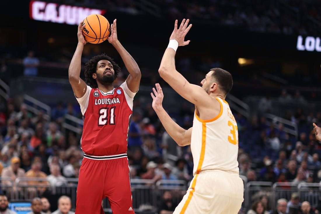 Mar 16, 2023; Orlando, FL, USA; Louisiana Ragin Cajuns forward Jordan Brown (21) shoots the ball over Tennessee Volunteers forward Uros Plavsic (33) during the first half at Amway Center. Mandatory Credit: Matt Pendleton-USA TODAY Sports