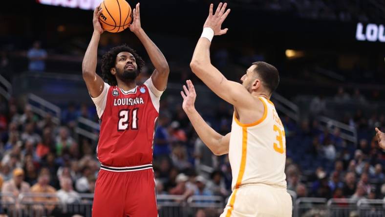 Mar 16, 2023; Orlando, FL, USA; Louisiana Ragin Cajuns forward Jordan Brown (21) shoots the ball over Tennessee Volunteers forward Uros Plavsic (33) during the first half at Amway Center. Mandatory Credit: Matt Pendleton-USA TODAY Sports