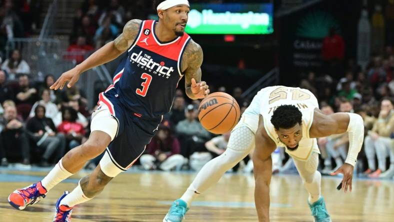 Mar 17, 2023; Cleveland, Ohio, USA; Washington Wizards guard Bradley Beal (3) and Cleveland Cavaliers guard Donovan Mitchell (45) go for a loose ball during the second half at Rocket Mortgage FieldHouse. Mandatory Credit: Ken Blaze-USA TODAY Sports