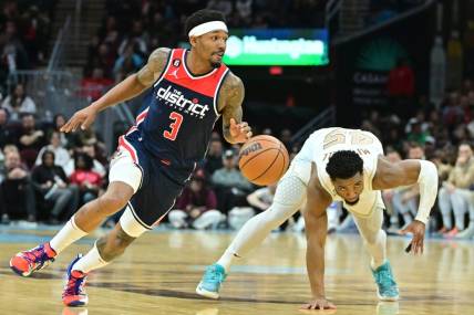 Mar 17, 2023; Cleveland, Ohio, USA; Washington Wizards guard Bradley Beal (3) and Cleveland Cavaliers guard Donovan Mitchell (45) go for a loose ball during the second half at Rocket Mortgage FieldHouse. Mandatory Credit: Ken Blaze-USA TODAY Sports