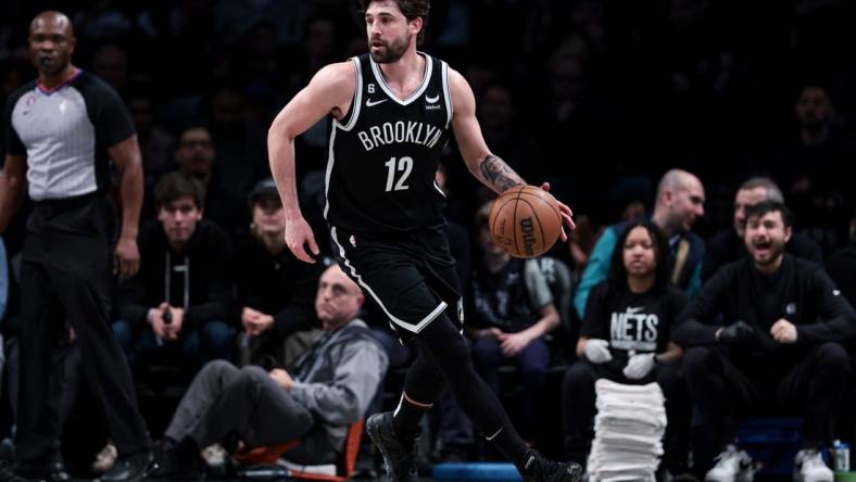 Mar 21, 2023; Brooklyn, New York, USA; Brooklyn Nets forward Joe Harris (12) dribbles during the first half against the Cleveland Cavaliers at Barclays Center. Mandatory Credit: Vincent Carchietta-USA TODAY Sports