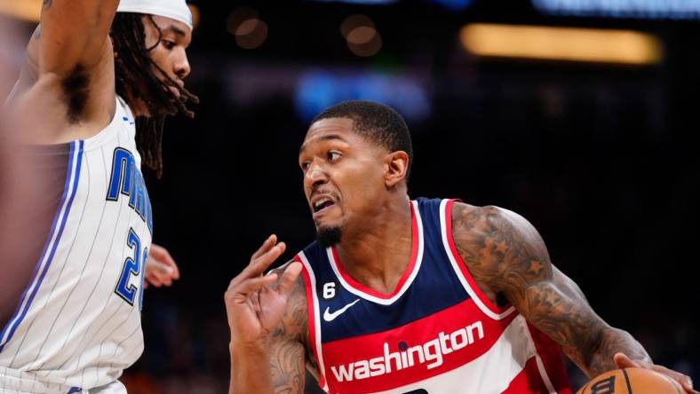 Mar 21, 2023; Orlando, Florida, USA; Washington Wizards guard Bradley Beal (3) dribbles the ball past Orlando Magic guard Markelle Fultz (20) during the second half at Amway Center. Mandatory Credit: Rich Storry-USA TODAY Sports