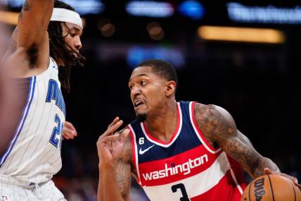 Mar 21, 2023; Orlando, Florida, USA; Washington Wizards guard Bradley Beal (3) dribbles the ball past Orlando Magic guard Markelle Fultz (20) during the second half at Amway Center. Mandatory Credit: Rich Storry-USA TODAY Sports