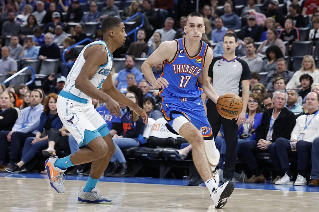 Mar 28, 2023; Oklahoma City, Oklahoma, USA; Oklahoma City Thunder forward Aleksej Pokusevski (17) dribbles the ball against Charlotte Hornets guard Theo Maledon (9) during the second half at Paycom Center. Charlotte defeated Oklahoma City 137-134. Mandatory Credit: Alonzo Adams-USA TODAY Sports