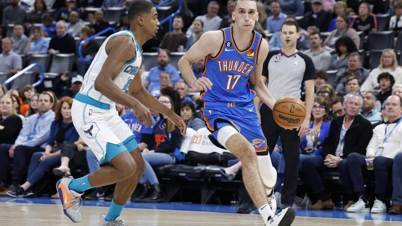 Mar 28, 2023; Oklahoma City, Oklahoma, USA; Oklahoma City Thunder forward Aleksej Pokusevski (17) dribbles the ball against Charlotte Hornets guard Theo Maledon (9) during the second half at Paycom Center. Charlotte defeated Oklahoma City 137-134. Mandatory Credit: Alonzo Adams-USA TODAY Sports