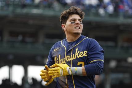 Mar 30, 2023; Chicago, Illinois, USA;  Milwaukee Brewers third baseman Luis Urias (2) reacts after being tagged out at first base during the ninth inning at Wrigley Field. Mandatory Credit: Kamil Krzaczynski-USA TODAY Sports