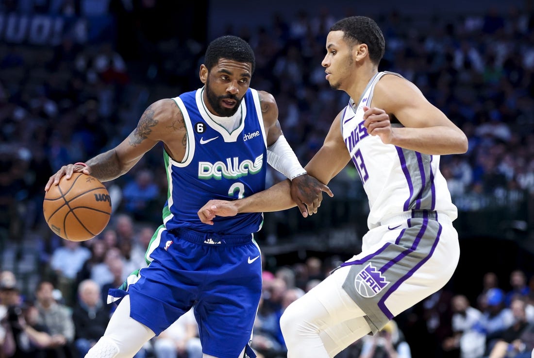 Apr 5, 2023; Dallas, Texas, USA;  Dallas Mavericks guard Kyrie Irving (2) drives to the basket as Sacramento Kings forward Keegan Murray (13) defends during the first half at American Airlines Center. Mandatory Credit: Kevin Jairaj-USA TODAY Sports